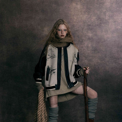 Model wearing MarkedLeather street style bomber jacket with contrast leather sleeves and graphic print