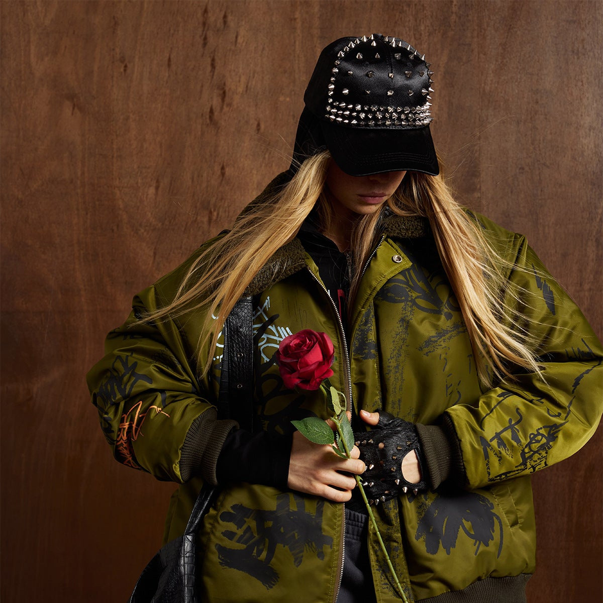 Streetwear combat olive graffiti print retro winter jacket worn by model showing loose fit and bold graphic design