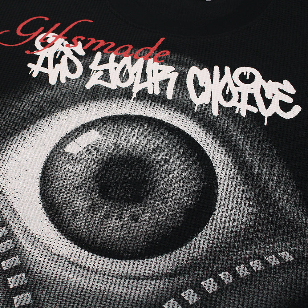 Close up of VoidVision eye graphic print on black streetwear long sleeve shirt fabric texture