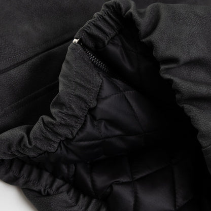 Close up detail of ARC NightDye black washed jacket hem texture and stitching vintage streetwear fabric