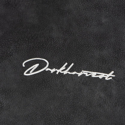 Close up embroidery detail of Darkharvest logo on ARC NightDye black vintage streetwear jacket