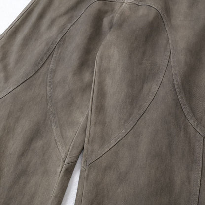 Close up detail of ARC DriftForm brown vintage washed denim pants stitching and panel construction