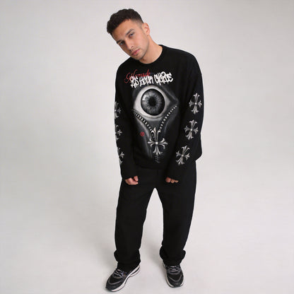 Male model posing in black VoidVision eye graphic long sleeve streetwear shirt with gothic cross sleeve prints